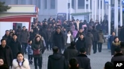  Pedestrians brave the cold, Jan. 30, 2020, in Pyongyang, North Korea. In an interview, North Korea's Ministry of Health Director Kim Dong Gu says the country is intensifying efforts to prevent the spread of a new virus from China.