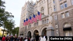 FILE - Hundreds protest Donald Trump at the opening of the International Trump Hotel at the Old U.S. Post Office Building in Washington, Oct. 26, 2016.