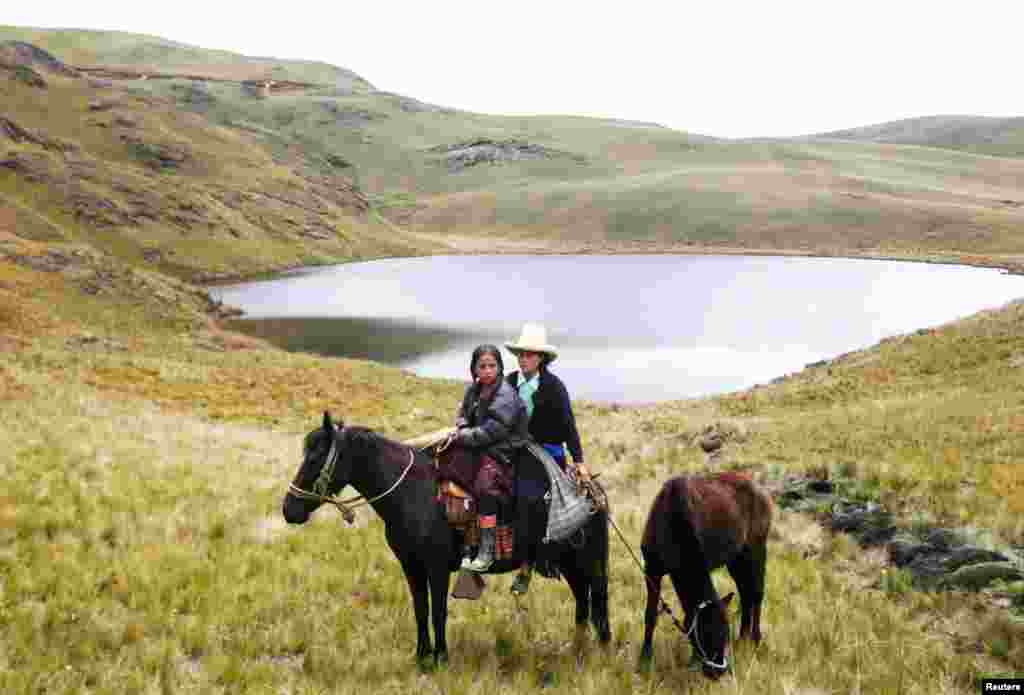 An Andean woman and a girl next to the Cortada lagoon during a march against Newmont Mining's Conga gold project at Peru's region of Cajamarca, Peru. (Reuters)