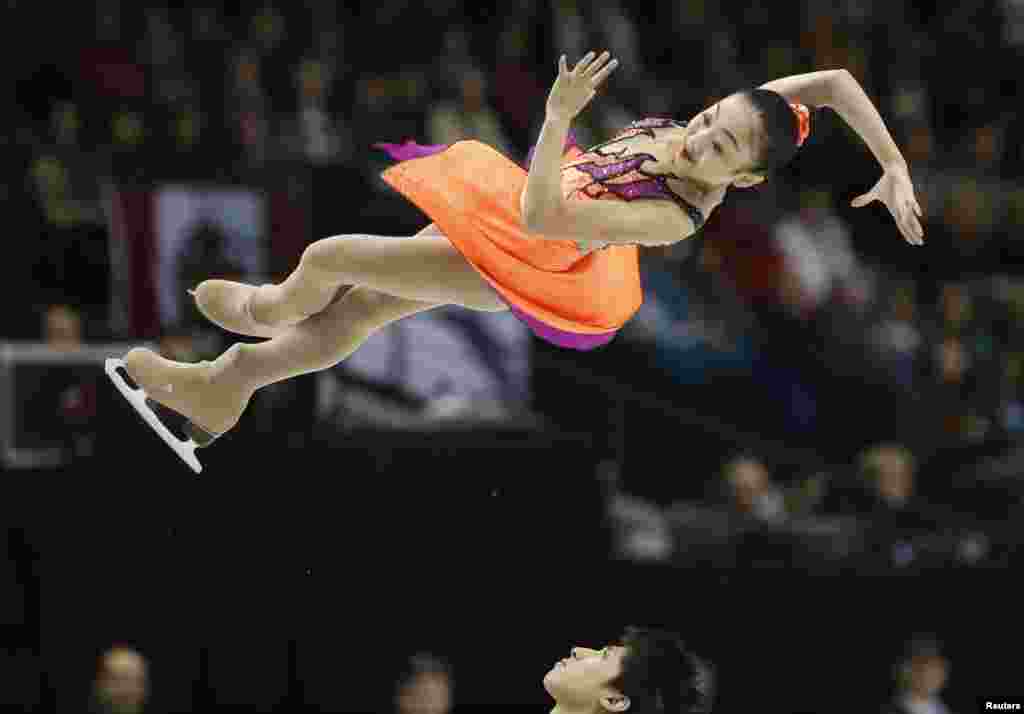 Sui Wenjing (top) and Han Cong of China perform in the pairs short program at the ISU World Figure Skating Championships in London.