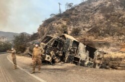 A burnt police water cannon, used to extinguish a wildfire, lies on the roadside near Kemerkoy Thermal Power Plant near Milas, a town in Mugla province, Turkey, Aug. 5, 2021.