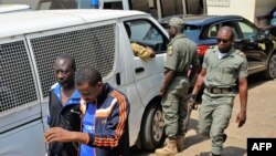 FILE - Men arrested in connection with Cameroon's anglophone crisis are seen at the military court in Yaounde, Cameroon, Dec. 14, 2018. Ten leaders of the separatist movement were sentenced to life in prison, Aug. 20, 2019.