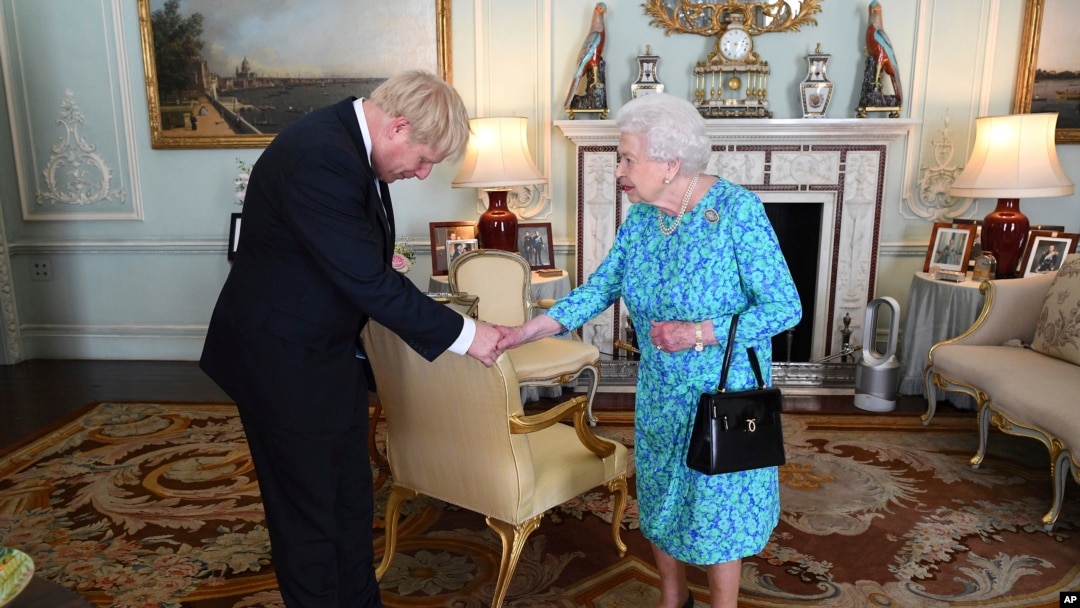 FILE - Britain's Queen Elizabeth II welcomes Boris Johnson, then newly-elected leader of the Conservative party, during an audience at Buckingham Palace, London, England, July 24, 2019.