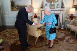 FILE - Britain's Queen Elizabeth II welcomes Boris Johnson, then newly-elected leader of the Conservative party, during an audience at Buckingham Palace, London, England, July 24, 2019.