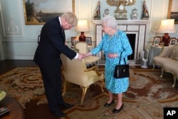 FILE - Britain's Queen Elizabeth II welcomes Boris Johnson, then newly-elected leader of the Conservative party, during an audience at Buckingham Palace, London, England, July 24, 2019.