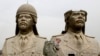 FILE - U.S. Army soldiers stroll past two bronze busts of former Iraqi president Saddam Hussein in the Green Zone in Baghdad, March 20, 2009, the sixth anniversary of the U.S.-led invasion of Iraq.