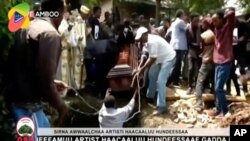 FILE - In this July 2, 2020, image taken from OBN video, the coffin of Ethiopian singer Hachalu Hundessa is lowered into the ground during his funeral in Ambo, Ethiopia.
