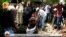 FILE - In this July 2, 2020, image taken from OBN video, the coffin of Ethiopian singer Hachalu Hundessa is lowered into the ground during his funeral in Ambo, Ethiopia.
