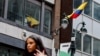 A woman walks near Colombia's consulate, after U.S. President Donald Trump said he would impose retaliatory measures after the South American country turned away two U.S. military aircraft with migrants being deported, in New York, Jan. 26, 2025.