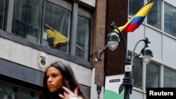 A woman walks near Colombia's consulate, after U.S. President Donald Trump said he would impose retaliatory measures after the South American country turned away two U.S. military aircraft with migrants being deported, in New York, Jan. 26, 2025.