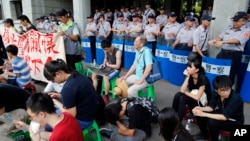 Student protesters against changes to their curriculum occupy the area inside the gates of the Ministry of Education in Taipei, Taiwan, Friday, July 31, 2015.