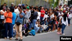 People line up outside a state-run Bicentenario supermarket in Caracas, Venezuela, Jan. 9, 2015.