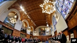 Judges, right, enter the World Court in The Hague, Netherlands, file photo. (AP Photo/Peter Dejong)