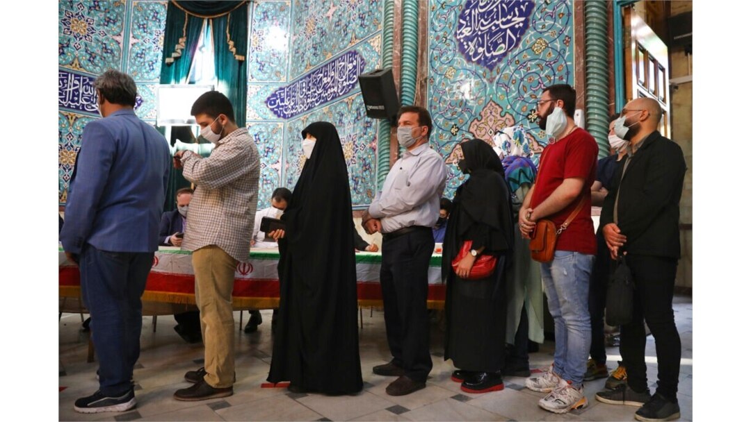 Voters queue at a polling station during the presidential elections in Tehran, Iran, June 18, 2021.