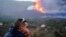 A man looks out on the Cumbre Vieja volcano as continues to erupt, on the Canary Island of La Palma, as seen from Tacande de Arriba, Spain, Oct. 2, 2021. 