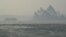 The Sydney Opera House can be seen as smoke haze from bushfires in New South Wales blankets the CBD in Sydney, Australia, Dec. 10, 2019. 