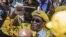 In this file photo taken on Nov. 8, 2017, Zimbabwe's then-President Robert Mugabe raises his fist as he greets party members and supporters gathered at his party headquarters.