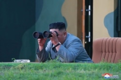 North Korean leader Kim Jong Un watches the test-fire of two short-range ballistic missiles Thursday, in this undated picture released by North Korea's Central News Agency, July 26, 2019.