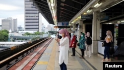 People wait for a Light Rail Transit train at a station, during a lockdown due to the coronavirus disease (COVID-19) outbreak, in Kuala Lumpur, Malaysia, Jan. 14, 2021.