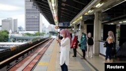 People wait for a Light Rail Transit train at a station, during a lockdown due to the coronavirus disease (COVID-19) outbreak, in Kuala Lumpur, Malaysia, Jan. 14, 2021.