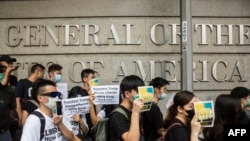 Protesters march past the U.S. Consulate to deliver a petition asking for support to oppose a proposed law that would allow extraditions to the Chinese mainland, in Hong Kong, June 26, 2019.