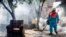FILE - A city worker sprays insecticide to combat the Aedes aegypti mosquitoes that transmit the Zika virus, at the San Judas Community in San Salvador, El Salvador, Jan. 26, 2016.