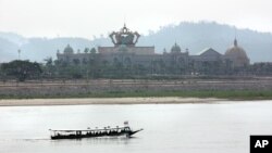 A boat on the Mekong River passes Chinese-run Kings Roman Casino in the special economic zone in Laos. (D. Schearf/VOA)