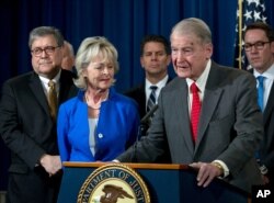 FILE - Former FBI Director William Webster, who was targeted by a man who peddled a lottery scam via phone calls and emails, addresses elder financial exploitation, at the Justice Department in Washington, March 7, 2019.