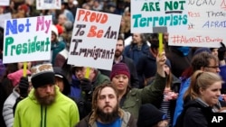 People begin to gather before a rally protesting President Donald Trump's travel ban on refugees and citizens of seven Muslim-majority nations, Jan. 29, 2017.