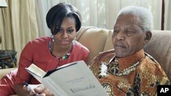 US First Lady Michelle Obama with former South African President Nelson Mandela at this home, in Houghton, South Africa, June 21, 2011. Before becoming president, Mandela was a key ANC leader for many years. (AP Photo/ Debbie Yazbek, Nelson Mandela Founda