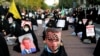 Iranian protesters hold defaced pictures of French President Emmanuel Macron during a protest against the publishing of caricatures of the Prophet Muhammad they deem blasphemous, in front of French Embassy in Tehran, Oct. 28, 2020. (AP/Ebrahim Noroozi)