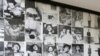 A tourist walks past photos of former prisoners displayed at Tuol Sleng genocide museum, a former Khmer Rouge prison known as S-21, in Phnom Penh.