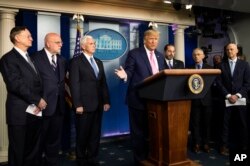 President Donald Trump, center, with members of the president's coronavirus task force speaks during a news conference at the Brady press briefing room of the White House, Feb. 26, 2020, in Washington.