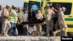 Rescue workers carry the body of a victim on a stretcher after a boat carrying migrants capsized off Egypt's coast, in Al-Beheira, Sept. 22, 2016. 