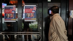 A person peeks into a U.S. election watch at a restaurant in Taipei, Taiwan, November 6, 2024. 