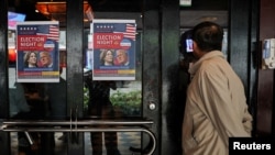 A person peeks into a U.S. election watch at a restaurant in Taipei, Taiwan, November 6, 2024. 