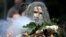 FILE - An Aboriginal man performs a smoking ceremony as protesters gather in Sydney, June 6, 2020, to support people in the US demonstrating over the death of George Floyd.