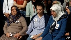 Family members of Osman Kose, a 38-year-old Turkish diplomat killed in Iraq, before his funeral prayers in Ankara, Turkey, Thursday, July 18, 2019. A gunman opened fire inside a restaurant in the northern Iraqi city of Irbil on Wednesday, killing a…