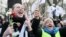Demonstrators cheer before the Constitutional Tribunal building In Warsaw, after the special court partly approved a move concerning its composition made by the previous ruling liberal Civic Platform party, Dec. 3, 2015.