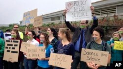 Protesters gather outside a meeting where a climate change report was to be released, Oct. 23, 2017, in Providence, Rhode Island. The EPA kept three scientists, who had been expected to discuss the report on the health of Narragansett Bay, from speaking at the event.