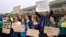 Protesters gather outside a meeting where a climate change report was to be released, Oct. 23, 2017, in Providence, Rhode Island. The EPA kept three scientists, who had been expected to discuss the report on the health of Narragansett Bay, from speaking at the event.