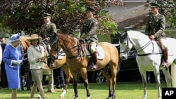 Britain's Queen Elizabeth II far left arrives at the National Stud Farm in Kildare, Ireland, May 19, 2011.