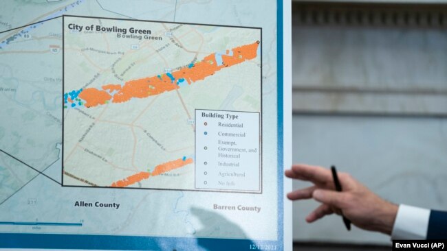 President Joe Biden points to a chart showing the path of tornado damage as he talks to reporters after receiving a briefing with Homeland Security Secretary Alejandro Mayorkas on the federal response to tornado damage, in the White House."
