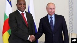 Russian President Vladimir Putin, right, shakes hands with Central African Republic President Faustin-Archange Touadera, in St. Petersburg, Russia, Wednesday, May 23, 2018. 
