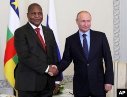 Russian President Vladimir Putin, right, shakes hands with Central African Republic President Faustin-Archange Touadéra, in St. Petersburg, Russia, Wednesday, May 23, 2018.