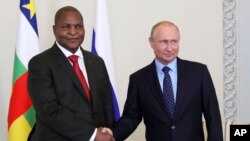 Russian President Vladimir Putin, right, shakes hands with Central African Republic President Faustin-Archange Touadera, in St. Petersburg, Russia, Wednesday, May 23, 2018. 