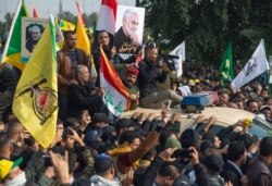 Mourners march during the funeral of Iran's top general Qassem Soleimani, and Abu Mahdi al-Muhandis, deputy commander of Iran-backed militias in Iraq known as the Popular Mobilization Forces, in Baghdad, Iraq, Jan. 4, 2020.
