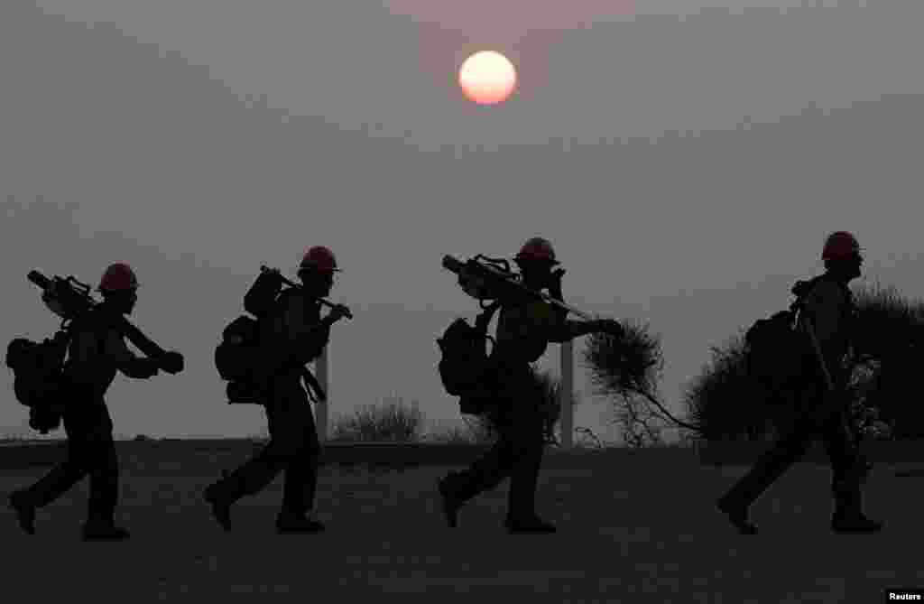A &quot;Hotshots&quot; crew walks after working to put out a fire near Mount Wilson Observatory, while battling the Bobcat Fire in Los Angeles, California, Sept. 14, 2020.
