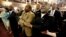Reverend Richard Harkness holds hands with Reverend Jack Lewin (2ndR)as the whole church sings "We Shall Overcome" at the close of a prayer vigil held at Morris Brown AME Church in Charleston, South Carolina, June 18, 2015.