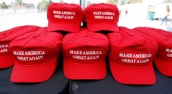 FILE - "Make America Great Again" hats available for purchase outside an arena in Tupelo, Miss., Nov. 1, 2019, ahead of a Keep America Great rally.